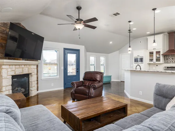 a living room with furniture fireplace and flat screen tv