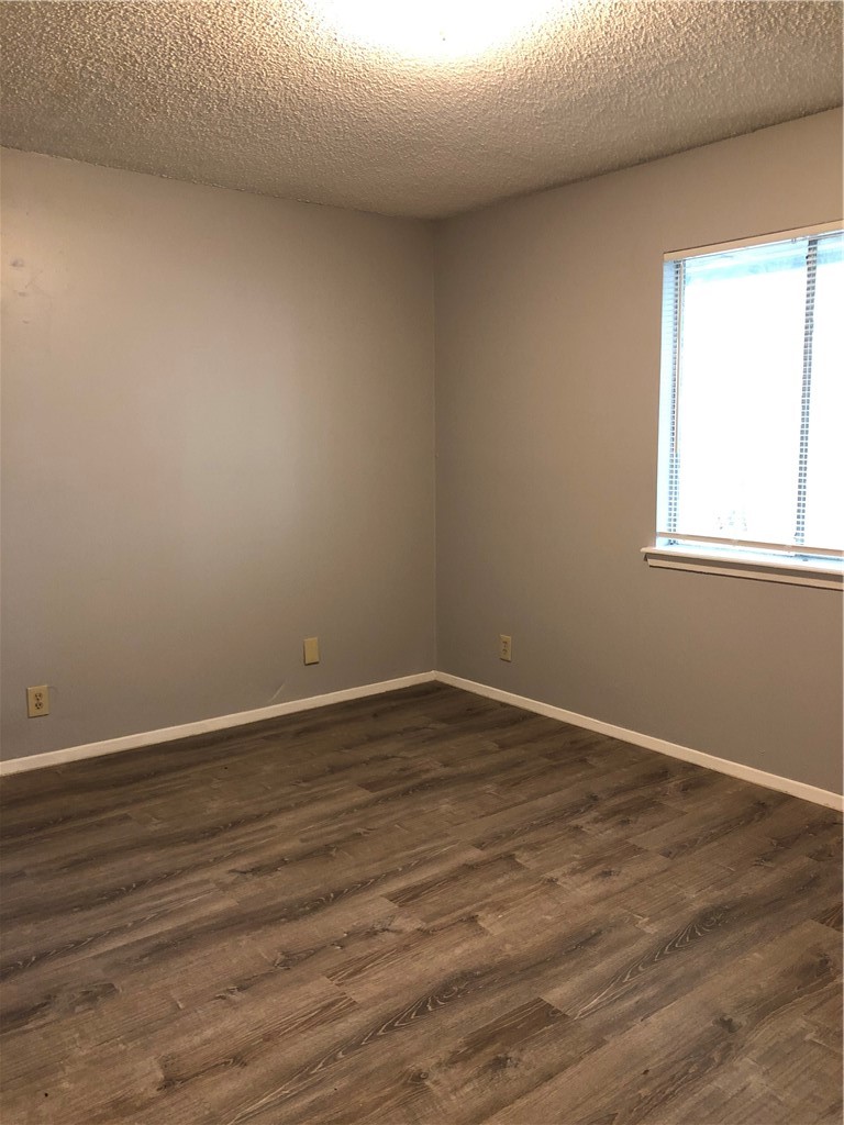 6502 South 1st Street, Unit 102 Austin, TX 78745 - Photo 15 of 26 an empty room with wooden floor and windows