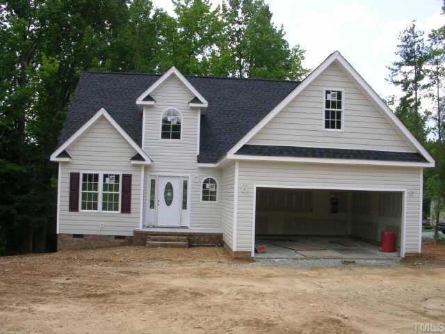 10 Punch Hill Farm Road Rougemont, NC 27572 - Photo 1 of 1 a front view of a house with a yard and garage