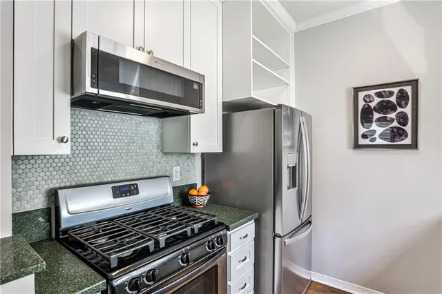 a kitchen with stainless steel appliances a stove and a refrigerator