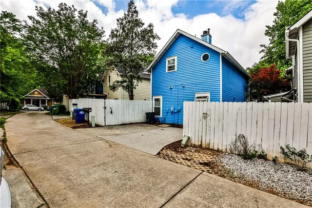a view of a house with wooden fence
