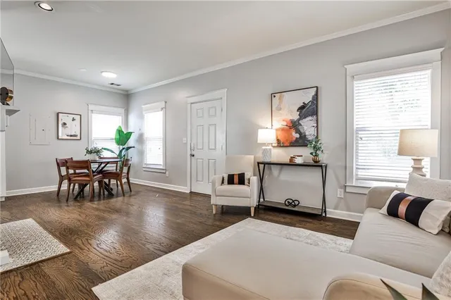 a living room with furniture and wooden floor