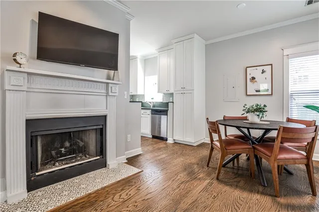 a living room with a wooden floor and a fireplace