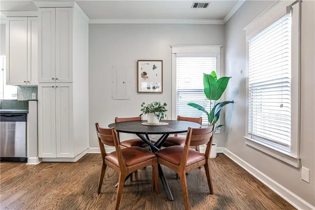 a view of a dining room with furniture and a potted plant