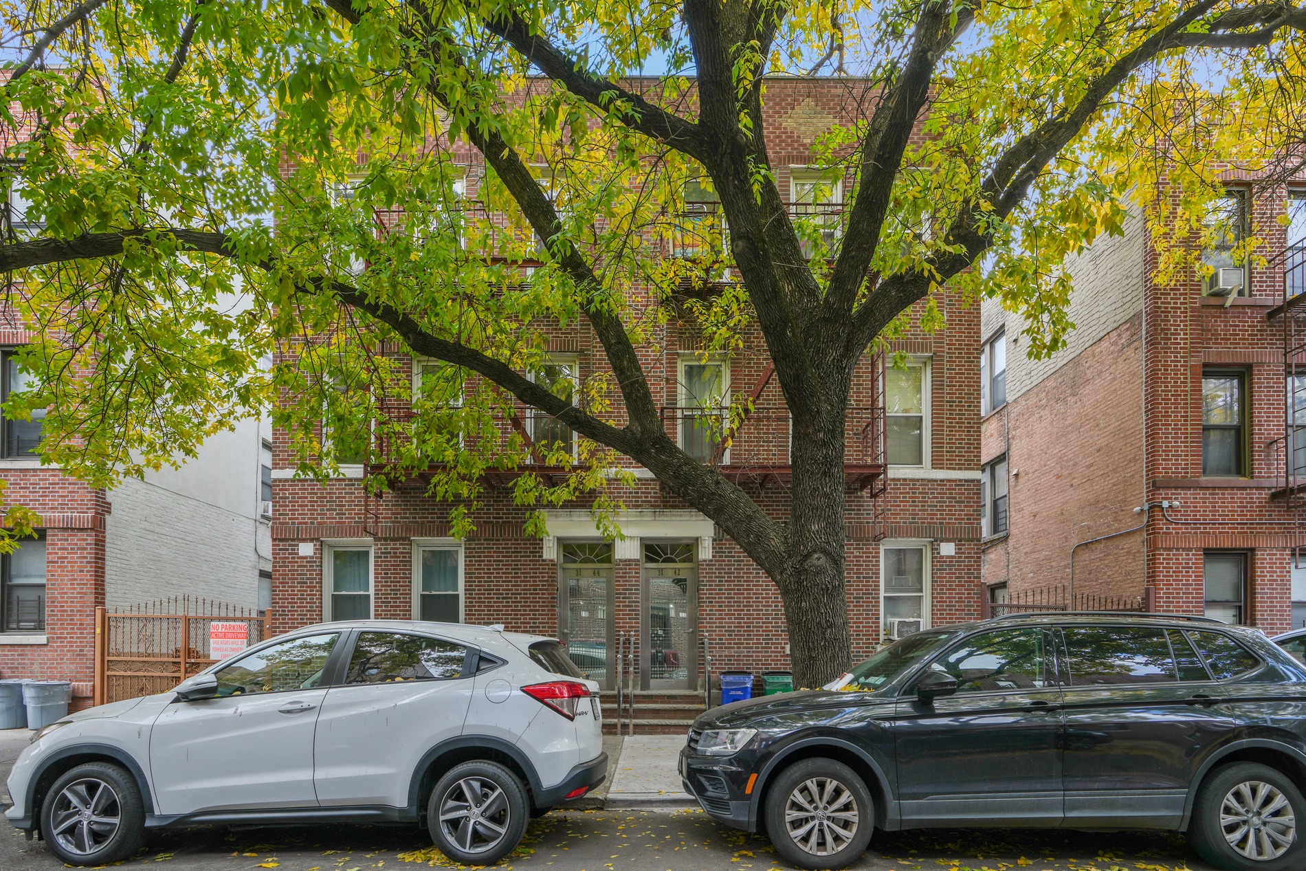 31-42 34th Street, Unit MULTIFAMILY Queens, NY 11106 - Photo 1 of 12 a front view of a house with parking space