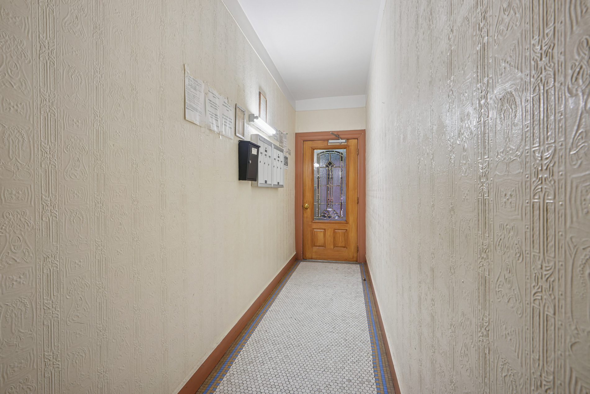 31-42 34th Street, Unit MULTIFAMILY Queens, NY 11106 - Photo 3 of 12 a view of a hallway with wooden floor and entryway