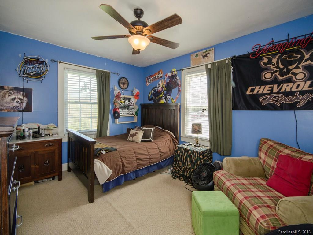 9 Star Ridge Road Canton, NC 28716 - Photo 8 of 13 a bedroom with a bed and a chandelier