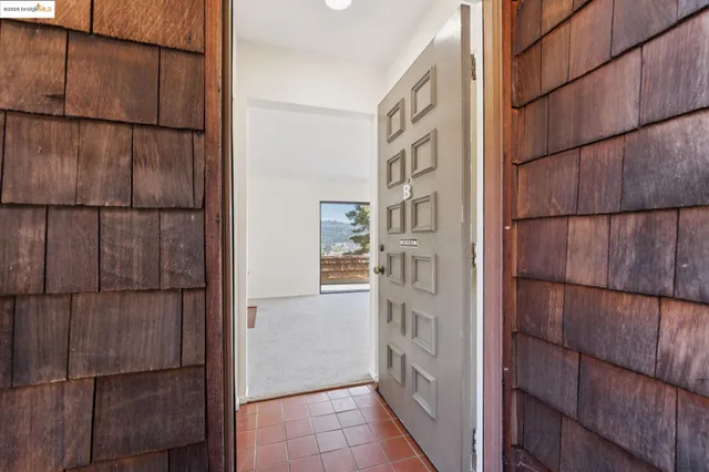 a view of a kitchen with wooden floor and electronic appliances