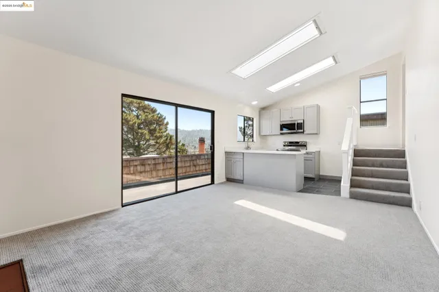 a view of an empty room with a fireplace