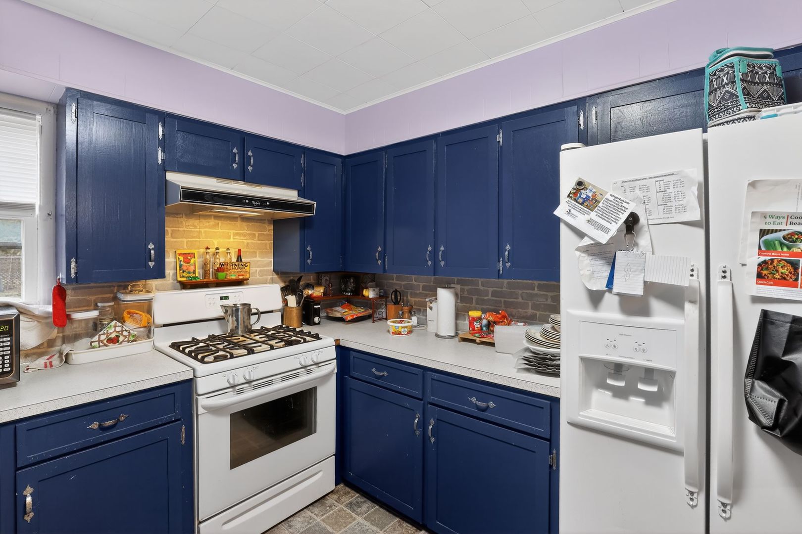 1006 Hester Avenue Centralia, IL 62801 - Photo 6 of 11 a kitchen with stainless steel appliances a stove a sink and a refrigerator