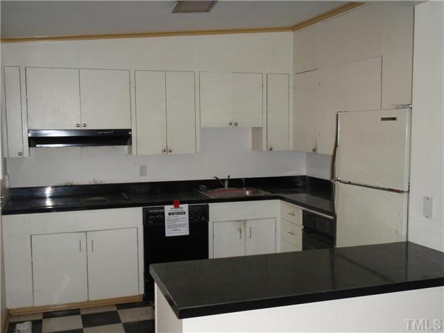 117 Bowden Road Chapel Hill, NC 27516 - Photo 2 of 12 a kitchen with a sink and cabinets