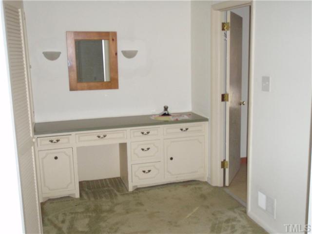 117 Bowden Road Chapel Hill, NC 27516 - Photo 7 of 12 a room with a mirror cabinets and a dresser