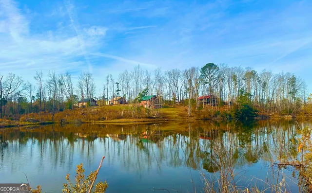 a view of a lake with houses in the back