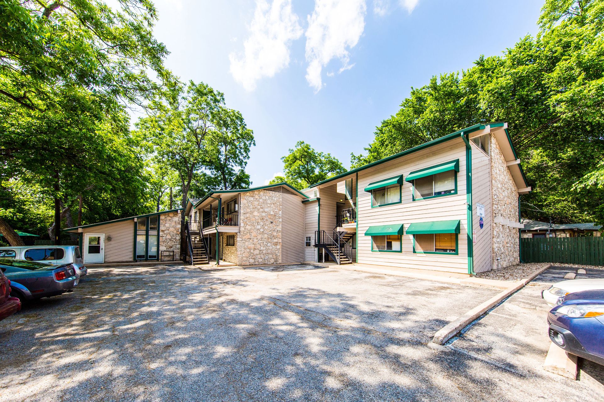 a view of a house with a big yard and large tree
