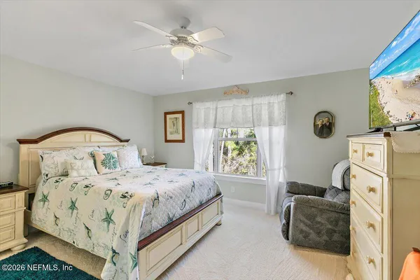 a bathroom with a granite countertop toilet sink and mirror