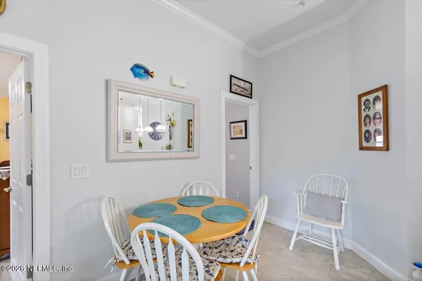 a room with a large window and sitting chair