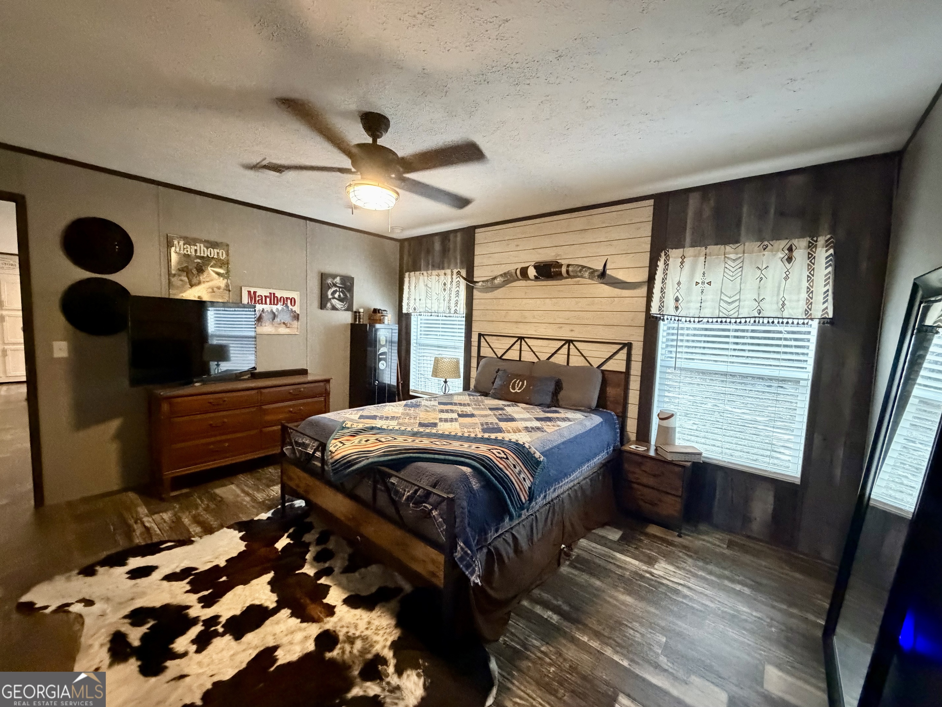 2601 New Evergreen Church Road Cadwell, GA 31009 - Photo 22 of 30 a bedroom with a bed and a flat tv screen on dresser