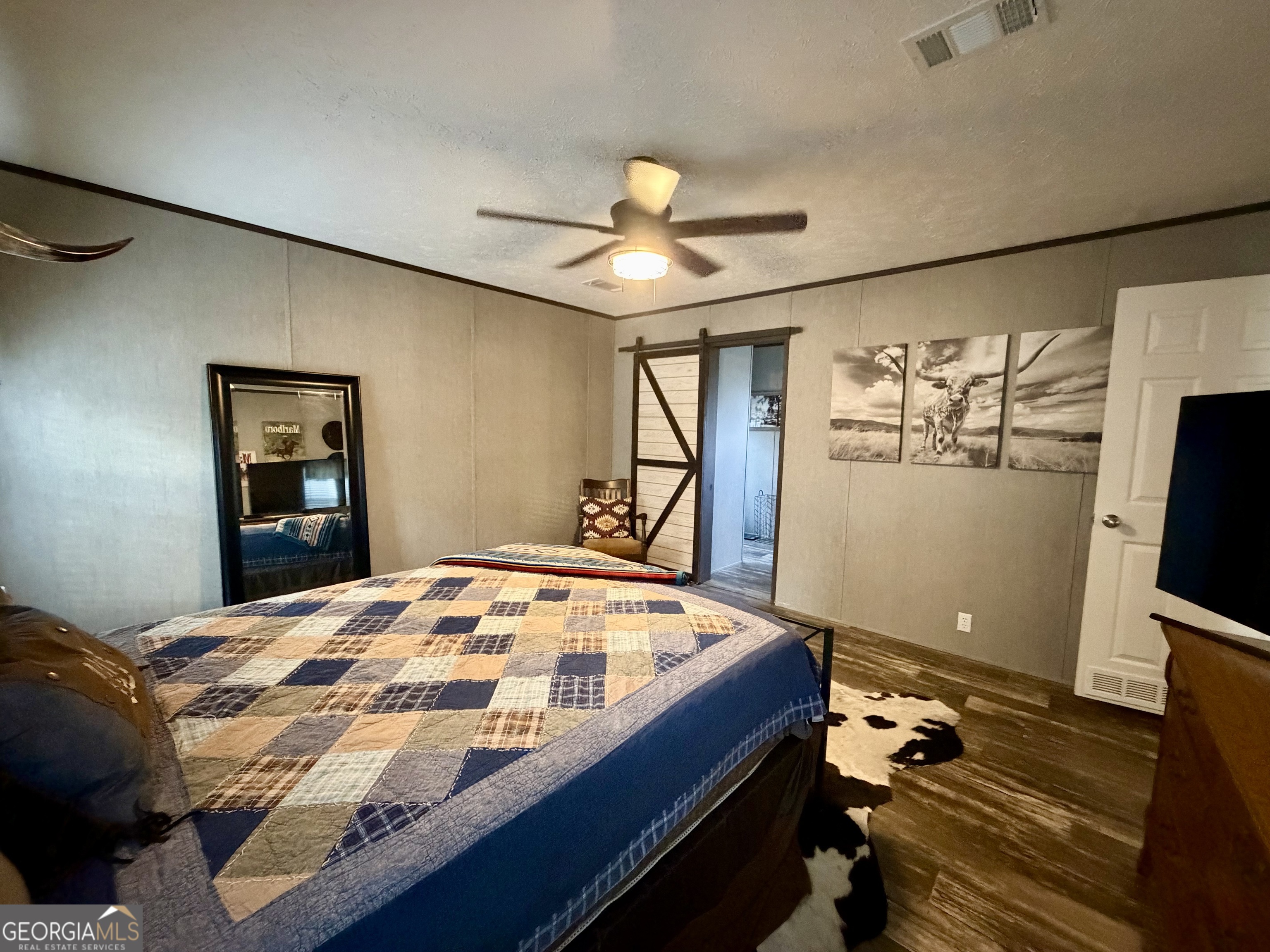 2601 New Evergreen Church Road Cadwell, GA 31009 - Photo 23 of 30 a bedroom with a bed and a flat screen tv