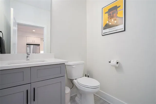 a bathroom with a toilet a sink and mirror