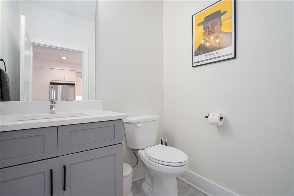 1649 Overlook Way Northwest Atlanta, GA 30324 - Photo 12 of 29 a bathroom with a toilet a sink and mirror