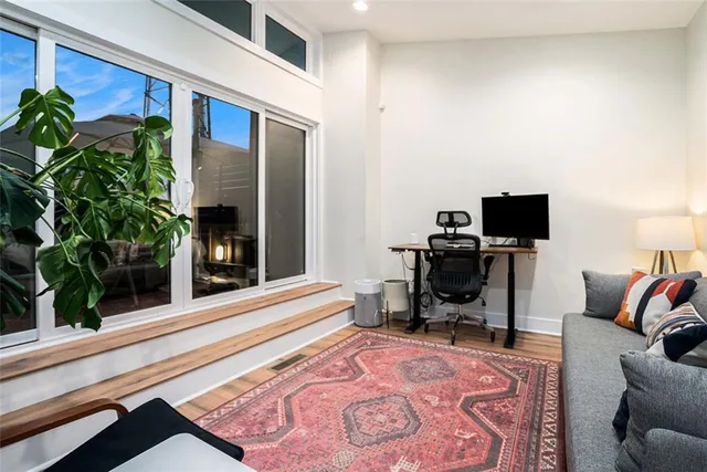 a living room with furniture and a potted plant
