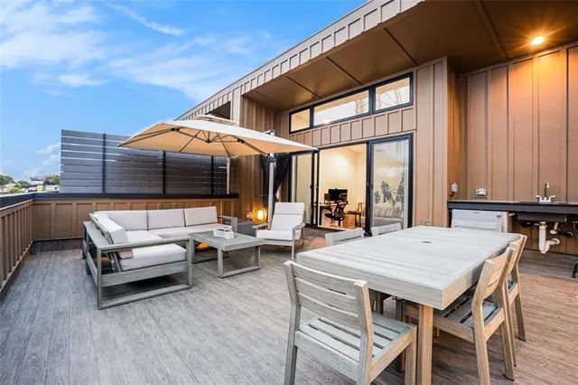 a view of a patio with couches and table under an umbrella