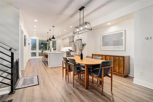 a view of a dining room with furniture wooden floor and chandelier