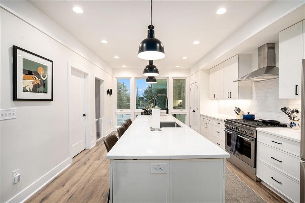 1649 Overlook Way Northwest Atlanta, GA 30324 - Photo 9 of 29 a kitchen that has a lot of white cabinets and a wooden floor