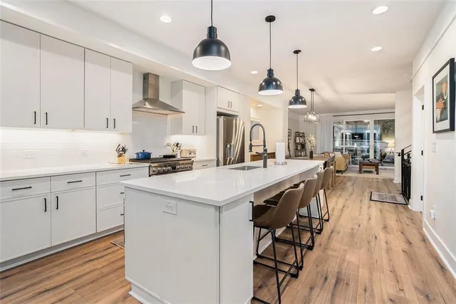 a kitchen with counter top space a sink appliances and cabinets