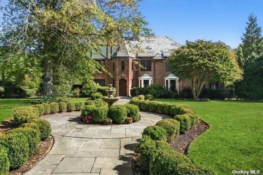 1315 Harbor Road Hewlett, NY 11557 - Photo 1 of 1 a front view of a house with a garden