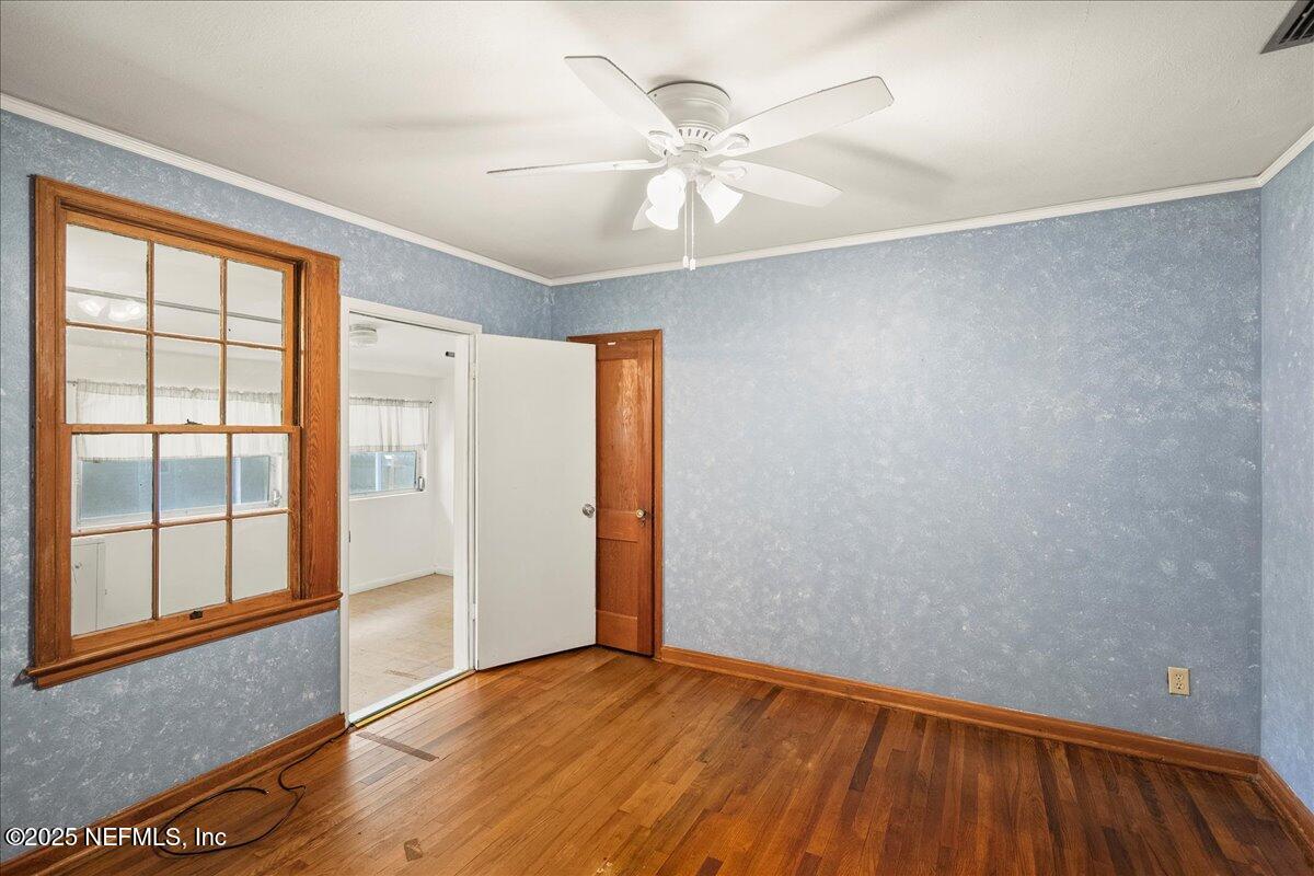 5249 Birkenhead Road Jacksonville, FL 32210 - Photo 15 of 32 wooden floor in an empty room with a window