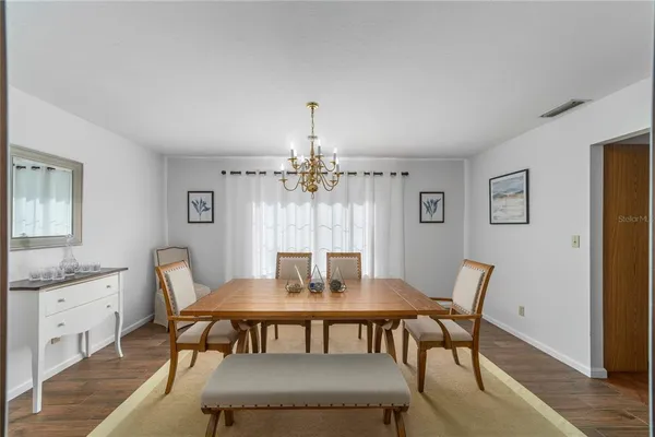 a view of a dining room with furniture and wooden floor