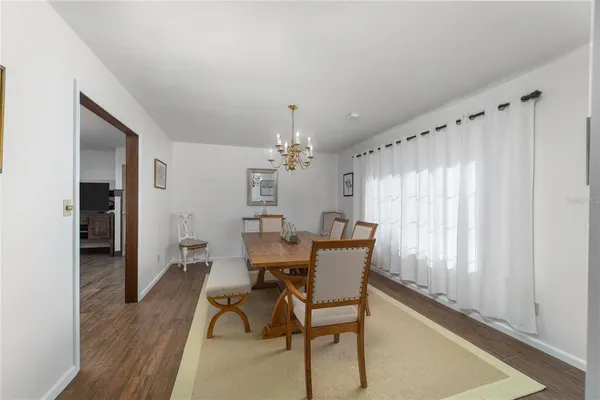 a view of a dining room with furniture and window