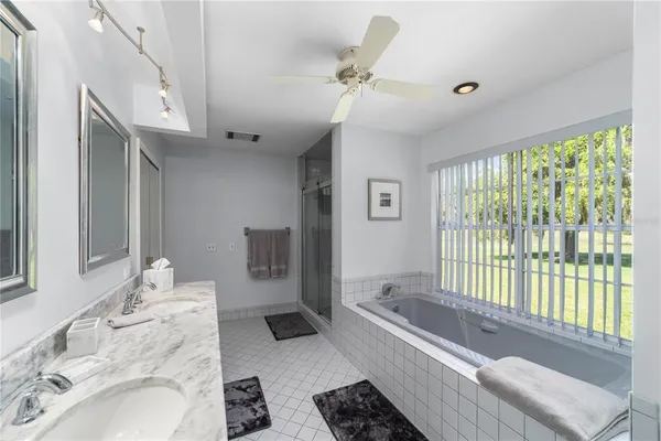 a spacious bathroom with a large tub and shower