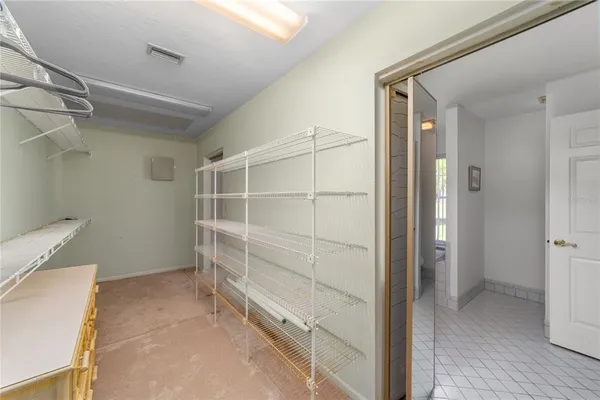 a view of walk in closet with empty racks