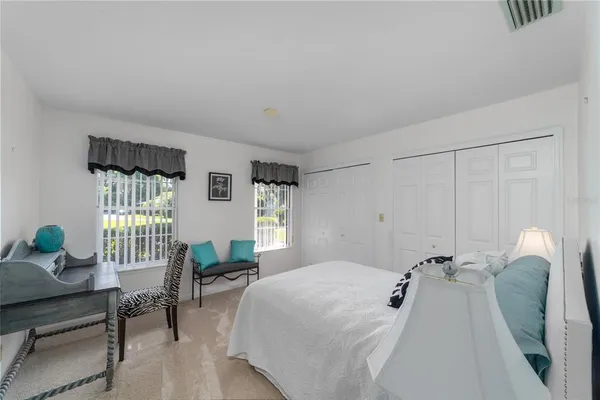 a bed room with a bed and a chair