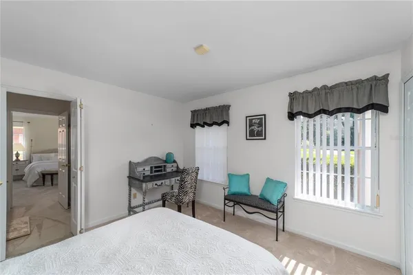 a bedroom with a bed a desk and chair
