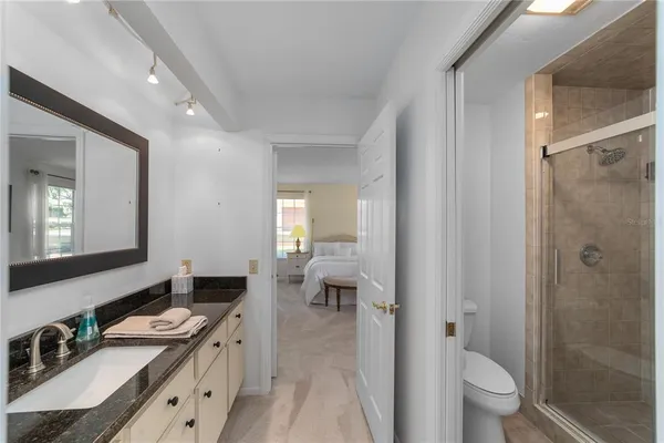 a spacious bathroom with a double vanity sink toilet and shower