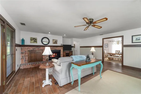 a living room with fireplace furniture and a wooden floor