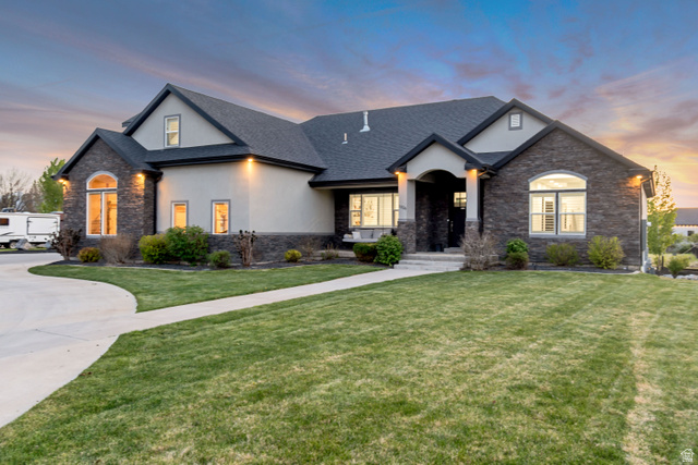 1526 South 500 West Mapleton, UT 84664 - Photo 41 of 54 View of front facade featuring stone siding, stucco siding, a lawn, roof with shingles, and driveway