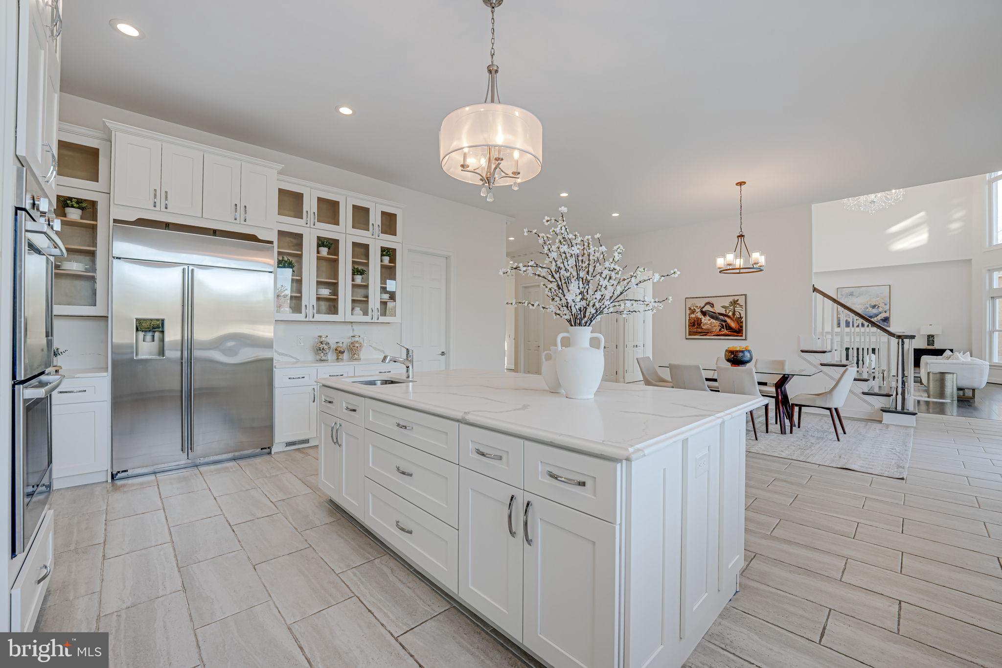 10305 Beach Mill Road Great Falls, VA 22066 - Photo 24 of 74 a kitchen with stainless steel appliances kitchen island granite countertop a sink of cabinets and glass door