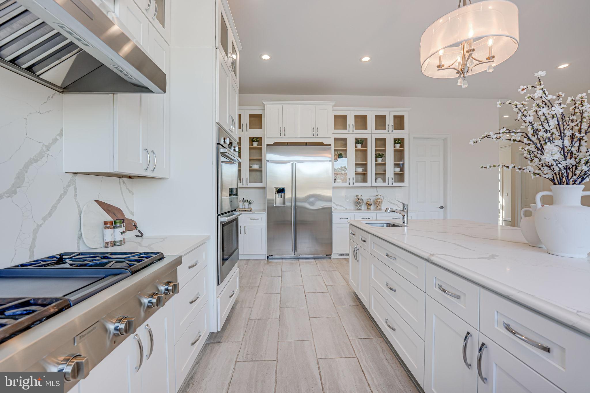 10305 Beach Mill Road Great Falls, VA 22066 - Photo 25 of 74 a large kitchen with stainless steel appliances granite countertop a lot of counter space and wooden floors