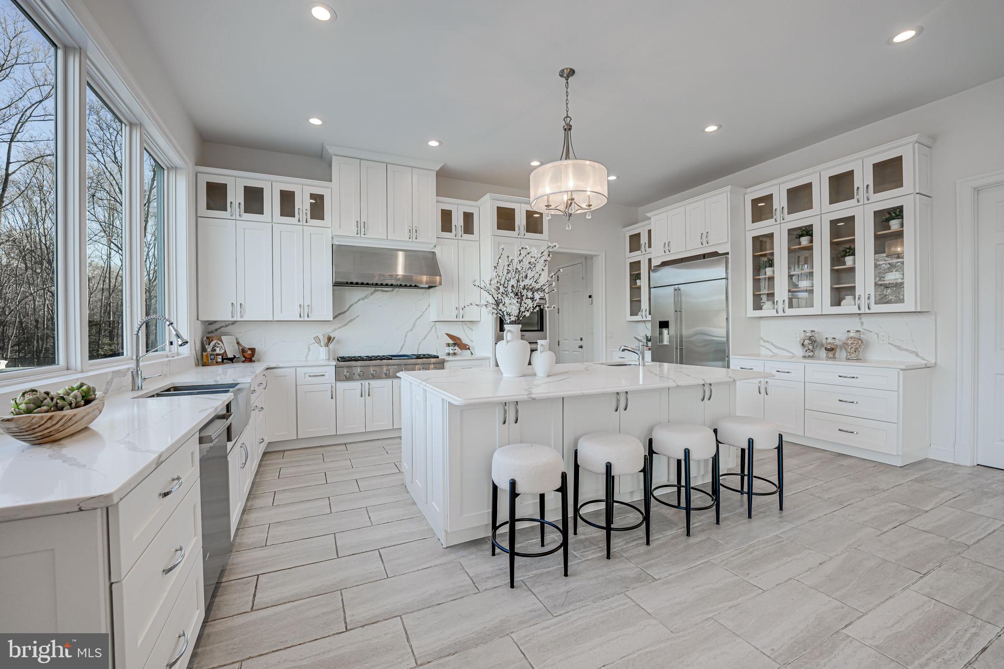 10305 Beach Mill Road Great Falls, VA 22066 - Photo 28 of 74 a large white kitchen with lots of counter space and appliances