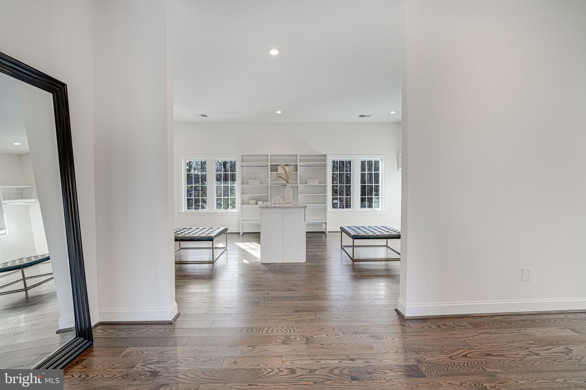 10305 Beach Mill Road Great Falls, VA 22066 - Photo 45 of 74 an empty room with wooden floor and a fireplace