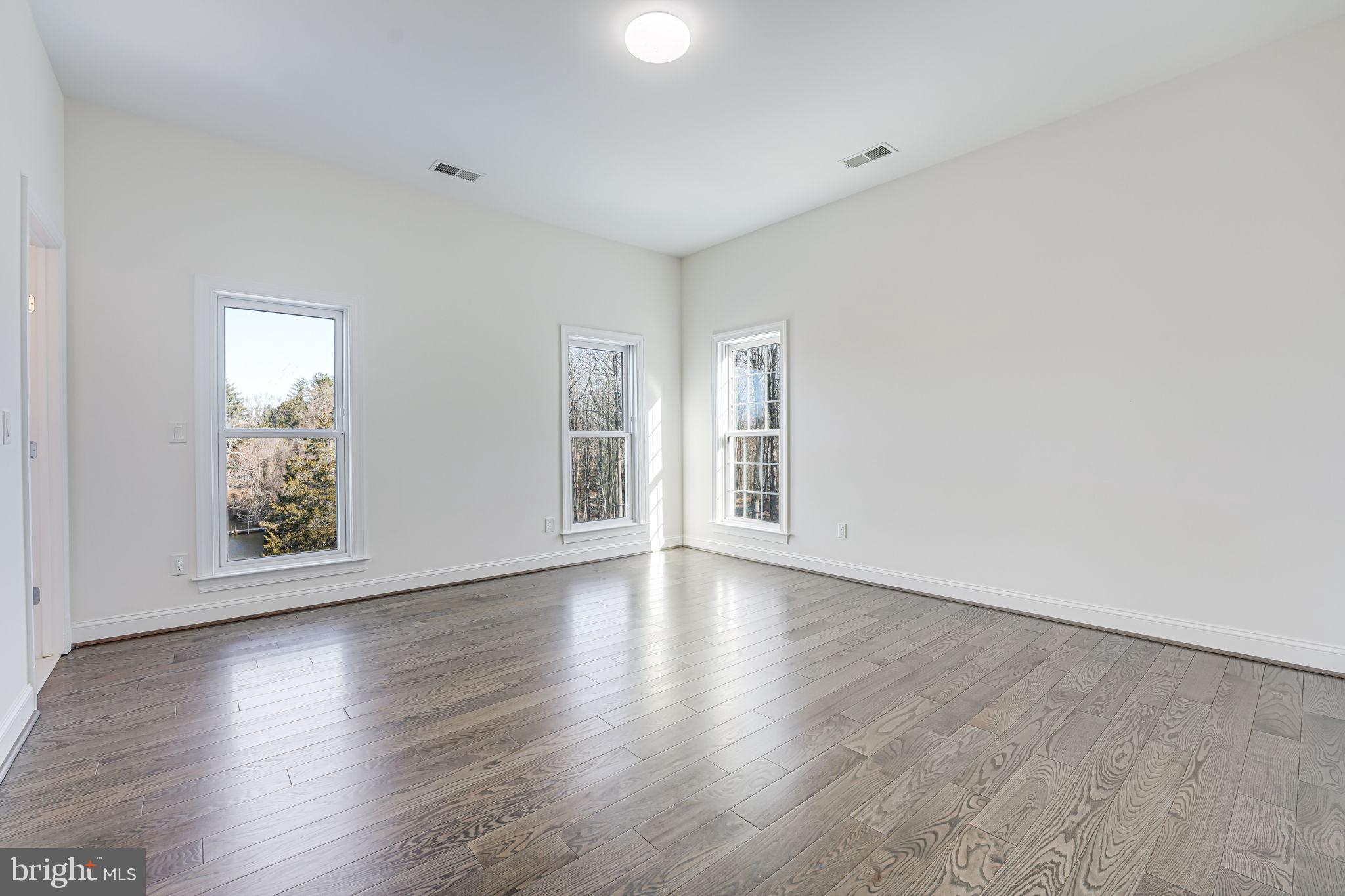 10305 Beach Mill Road Great Falls, VA 22066 - Photo 56 of 74 a view of an empty room with wooden floor and a window