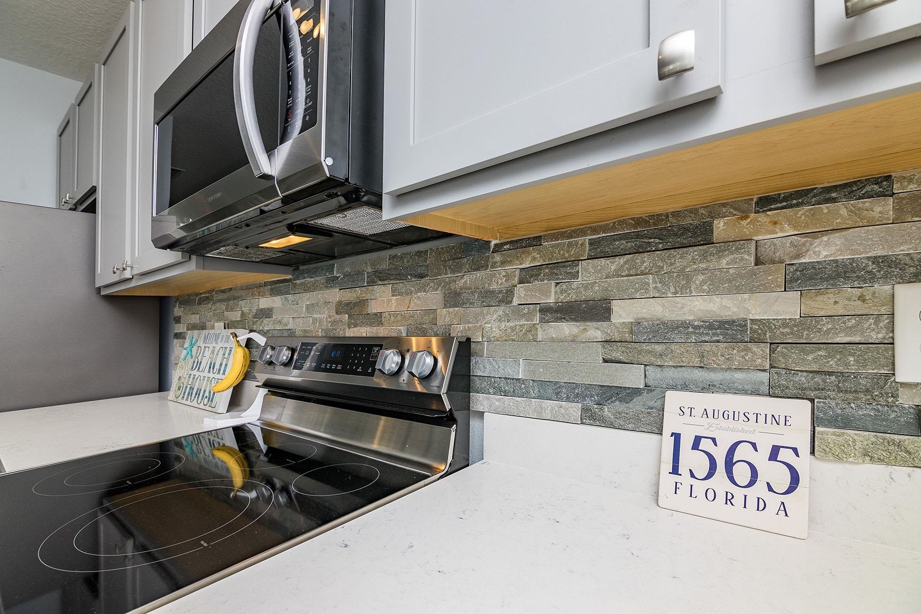 74 Ridge Lake Road St. Augustine, FL 32086 - Photo 16 of 47 a kitchen with a stove and a microwave