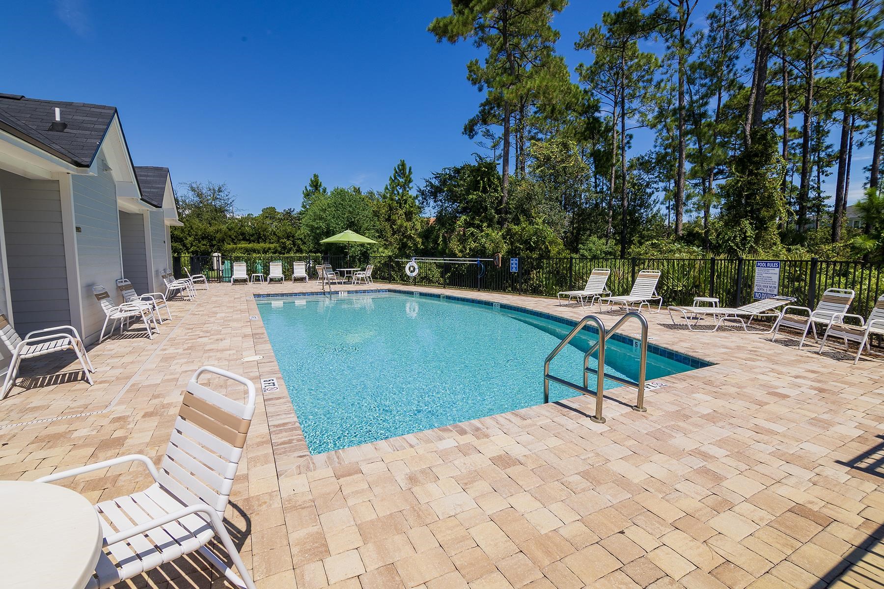 74 Ridge Lake Road St. Augustine, FL 32086 - Photo 40 of 47 a view of a swimming pool with a lounge chair