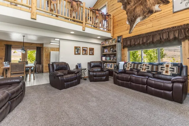 a living room with furniture a large window