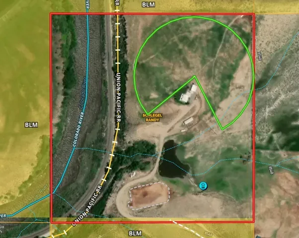 an aerial view of a residential houses with yard