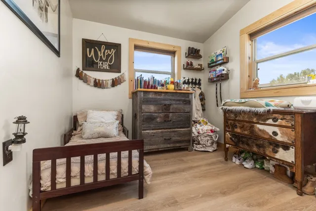 a bedroom with furniture and a baby crib